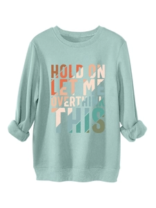 Detail of mint green sweatshirt with retro geometric Hold On Let Me Overthink This print
