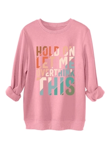 Detail of pink fleece sweatshirt showing retro 'HOLD ON LET ME OVERTHINK THIS' text print