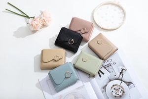 Detailed view of women's tri-fold leather wallets with circular metal hardware