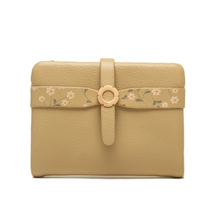Macro detail of khaki leather wallet with floral print strap and golden circular buckle