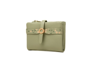 Detail view of lychee pattern leather wallet with floral strip and golden ring buckle