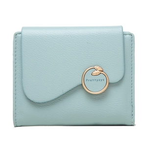 Detail of light blue tri-fold wallet with lychee leather texture and gold leaf buckle