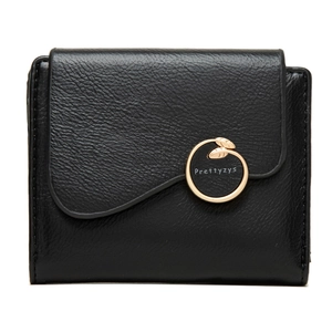 Detail of black pebbled leather wallet featuring a gold leaf-shaped metal clasp closure