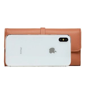 Brown lychee grain leather long wallet with flap closure next to a phone for scale