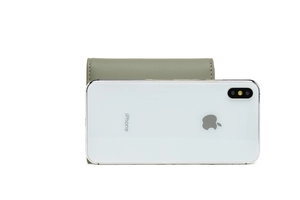 Olive green compact tri-fold wallet compared with an iPhone to show the portable size