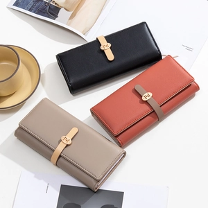 Flat lay of minimalist tri-fold long wallets with metal logo buckle in multiple colors
