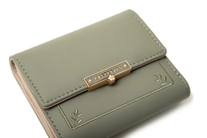 Detail of sage green PU leather wallet featuring leaf embroidery and gold metal clasp