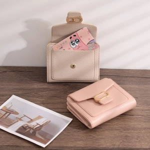 Close-up of litchi pattern PU leather wallets with gold buckles and card slots