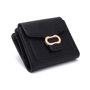 Close-up of black lychee grain leather wallet featuring elegant gold oval metal buckle