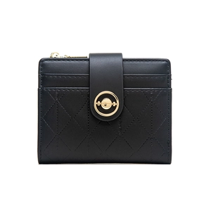Close-up of black quilted leather wallet with gold hardware and metal snap button