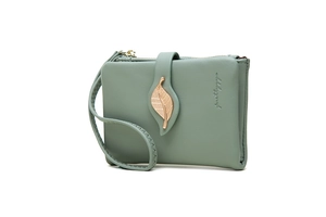 Detail of green PU leather wallet featuring a gold leaf ornament and wrist strap