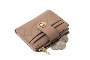 Detail of pink quilted short wallet with gold buckle and functional coin pocket