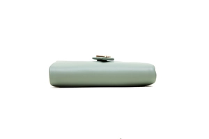 Side view of mint green matte leather wallet showing stitching and buckle detail
