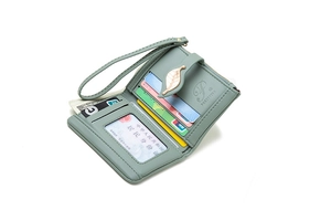 Detail view of light green PU leather wallet interior with card slots and metal leaf buckle