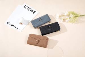 Three long frosted PU leather wallets with vintage metal clasps in a lifestyle setting