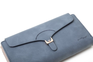 Close-up of matte PU leather texture with metal snap buckle on long envelope wallet