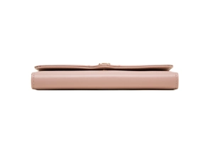 Detail view of pink leather long wallet showing fine stitching and gold hardware buckle