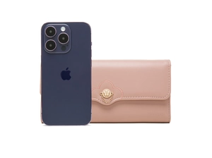 Close-up of pink long wallet with floral metal buckle and size reference beside a phone