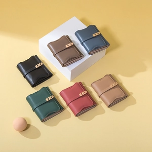 Flat lay of colorful tri-fold wallets in six colors with elegant metal buckles