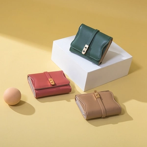 Three elegant leather folded wallets in green, red, and brown with gold metal buckles