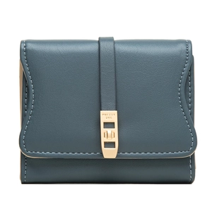Macro detail of teal blue trifold wallet featuring golden metal clasp and fine stitching