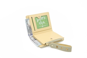Detail view of a yellow bi-fold wallet featuring heart-shaped charms and a coin pocket