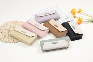Detailed top view of long PU leather wallets in six colors with floral patterns and buckles
