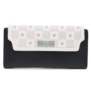 Detail of checkered floral pattern on black leather long wallet with green metal buckle