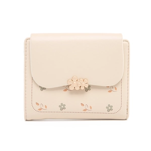 Close-up of floral print pattern and metal flower clasp on beige short wallet for women