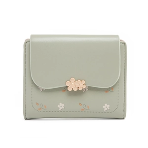 Close-up of light green PU leather wallet with gold floral clasp and floral print detailing