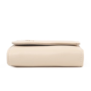 Detail view of beige PU leather wallet featuring precise white stitching and side embossed logo