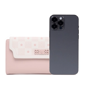 Pink and white wallet with cherry blossom print and bow hardware next to a phone