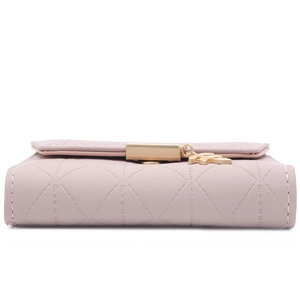 Detailed close-up of a pink quilted faux leather wallet with a gold leaf pendant and clasp