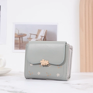 Detail of light green floral PU leather short wallet with a golden flower buckle clasp