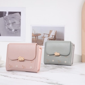 Detail of sweet floral PU leather wallets with flower metal buckles in pink and mint green