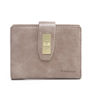 Detail of vintage pink PU leather folding wallet with gold rectangle clasp and logo