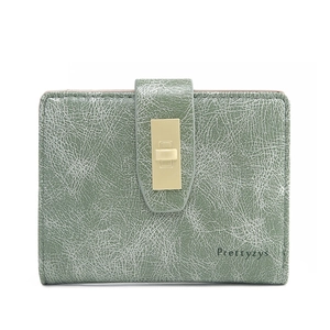 Detailed view of green faux leather wallet with white crackle texture and metal buckle
