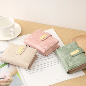 Detailed view of three PU leather wallets with buckle closure in pastel colors