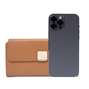 Brown faux leather long wallet with leaf buckle shown next to a smartphone for size reference