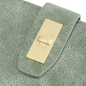 Close-up of litchi texture green leather wallet with gold rectangular metal clasp buckle