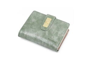 Detail of sage green faux leather wallet with gold metal buckle and vintage cracked texture