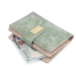 Detail of short fold wallet in sage green featuring retro cracked leather texture