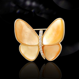 Elegante broche de mariposa con nácar naranja y diamantes sobre base dorada