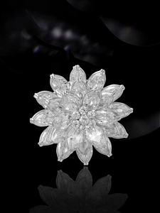 Macro detail of luxury triple-layer lotus flower brooch with marquise-cut stones