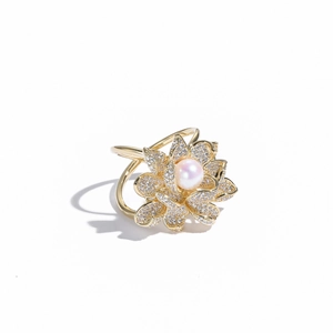 Macro shot of gold lotus brooch with micro-pave zircons and a natural pink pearl center