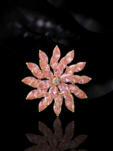 Detail view of pink zircon rotating flower brooch with multi-layer marquise cut petals
