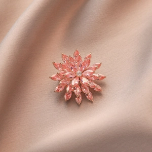 Close-up of pink zircon spinning brooch flower with rose gold plating on silk