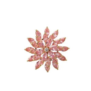 Detailed close-up of rotating floral brooch with pink marquise-cut crystals and gold finish