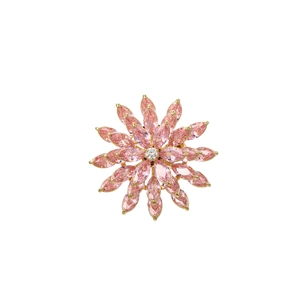 Detailed view of spinning pink zircon flower brooch with gold plating and marquise petals