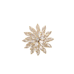 Macro detail of rotating pink zircon floral brooch with sparkling marquise petals